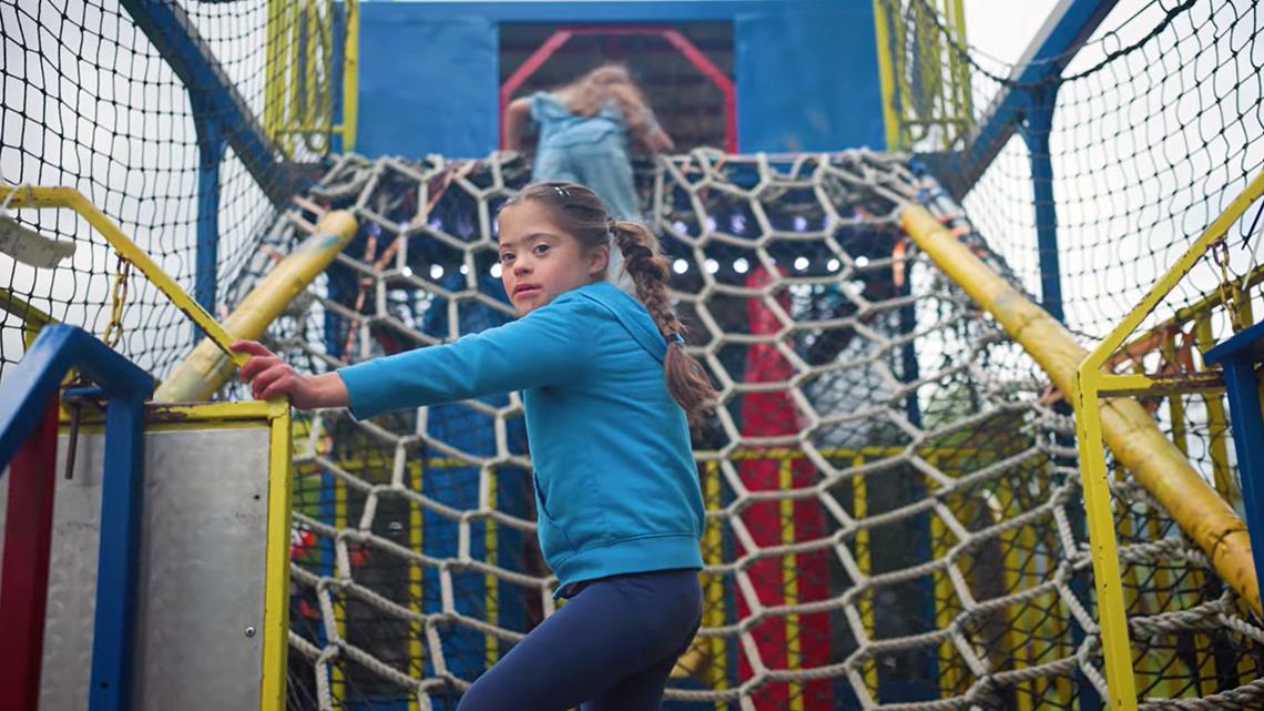 A girl plays on a climbing structure